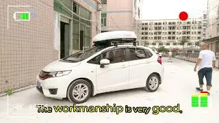 The small car Honda Fit is equipped with a NEUMANN roof rack, a roof box and a car spoiler.