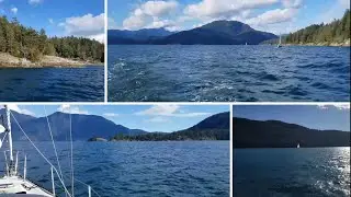 Relaxing motorsailing by forested island