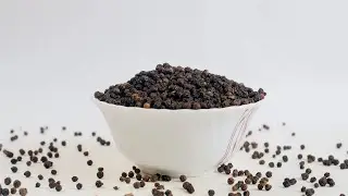 Shot of falling peppercorns / black pepper/kali mirch in a whi... | Indian Stock Footage | Knot9