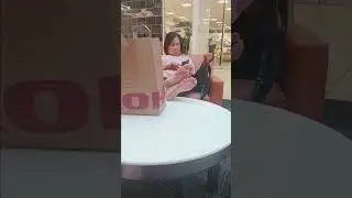 Old asian lady puts her bare feet up in public to take a break from shopping