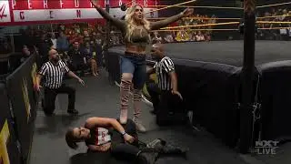 Charlotte Flair victory pose on Rhea Ripley 