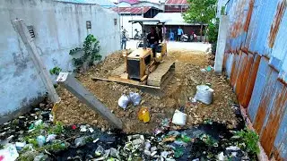 The trash and marsh cover by bulldozer push stone and dump truck