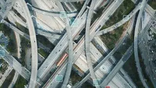 Top down footage of traffic on complex multilevel multilane highway interchange. Visual effects of