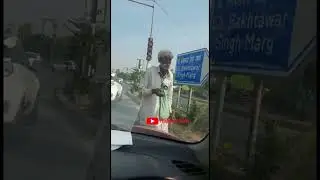 old man begging at red light