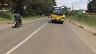 Precious students cheering from bus windows in Usariver area
