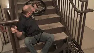 Ascends stairs: transfer from wheelchair to stairs