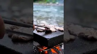 Meat is cooked on a stone slab near the river.😉😊