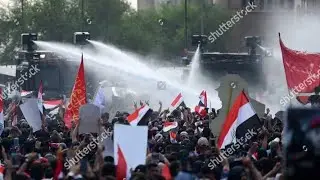 Iraqi riot police use water cannon to disinfect streets of Basra