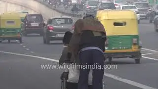 Man pushes patient in wheelchair : Inner Ring Road winter fog | Car gridlock at Safdarjung Hospital