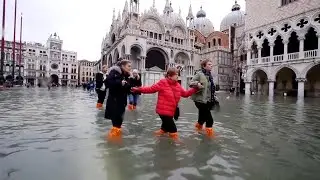 Woman's Luggage Floats Along Flooded Streets of Venice
