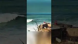 Epic Cliffside View: Red Roof Building Meets Crashing Waves!