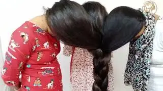 three girls gathered their long hair and made front  long hair braids