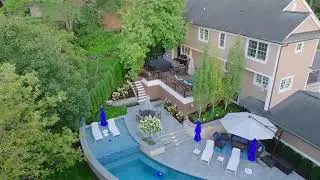 Luxury Arched Pool Design | Raised Sun Shelf, Water Scuppers & Bluestone Patio in Ann Arbor, MI