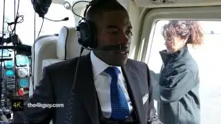4K UHD - Pretty female pilot welcomes black man passenger into helicopter