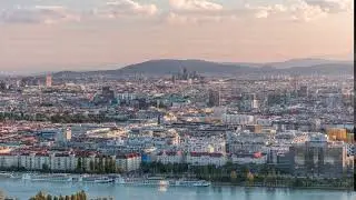 Aerial panoramic view of Vienna city with skyscrapers, historic buildings and a riverside promenade
