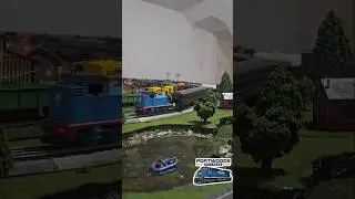 Thomas pulling Santa Fe passenger cars in Reverse on HO scale train layout.