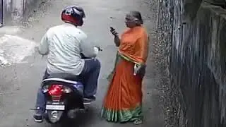 Bike thief snatching chain from old lady