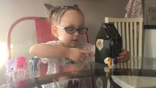 Storey opening a Mystery Mini: Alice Through the Looking Glass