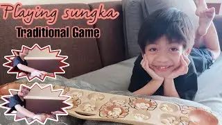 Playing sungka / Traditional Game / Filipino game