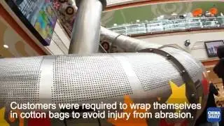 Journalist tries out huge slide in Shanghai shopping mall