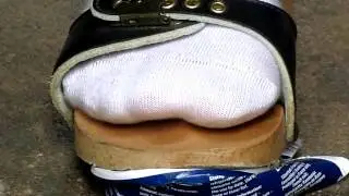Blue exercise sandals flattening a blue cheese pack