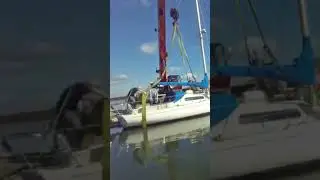 Crane Lifting A Sailboat