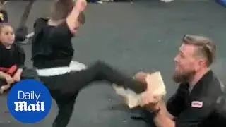 Karate kid finally manages to break a board after class cheers