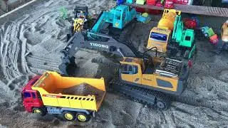 The excavator and truck loaded the sand very heavily. Types of construction vehicles