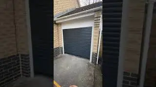 Electric insulated 77mm slat roller door in anthracite grey.