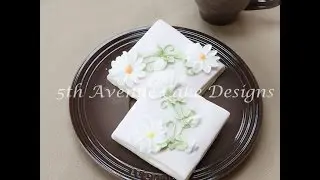 Royal Icing Piped Daises on a Flower Nail