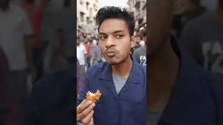 A boy is eating chicken in a crowd on the road. #chicken