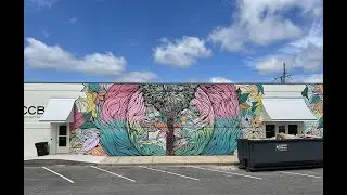 Artist Nathan Brown paints a flowy animal mural in Defuniak Springs, FL