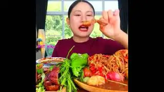 Eating spicy papaya salad with fermented fish sauce, grilled pork neck, acacia leaves,