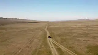 Adventure in the Rugged Mountains With Offroad Car Traversing Vast Desert Terrain at Sunset