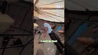 The operator is showing riders how to stand in the Gravitron ride!