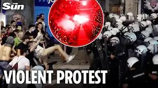 Demonstrators hurl flares at riot police as 140,000 Serbians hit streets to demand snap election