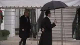 Trump departs for London, decries impeachment hoax