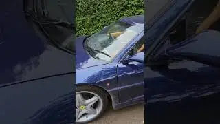 Beautiful example of dark blue Ferrari F355 GTS 3.5 coupe in countryside estate in Wiltshire, UK.