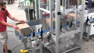 Performance Feeders custom conveyor system transfers packages between a cleanroom and a warehouse