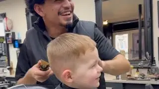 Adorable kid can't stop laughing while getting his hair trimmed || WooGlobe