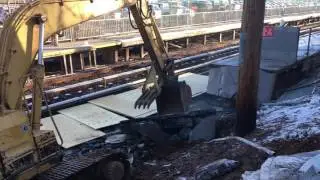 Train station demolition using caterpillar excavator