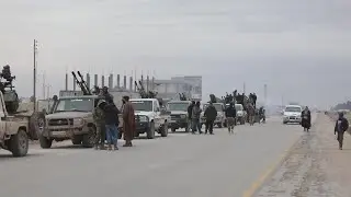 Syrian military vehicles prepare to enter Kurdish-held town east of Aleppo | AFP