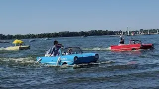 21 Amphicars going from Lake Dora to Land. 2022 Tavares Classic Boat & Car Show