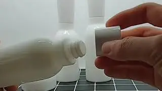 Empty opal glass pump bottle and opal glass jar
