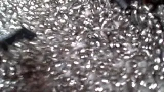 65 Deflashing of plastic parts in a vibratory finishing machine.