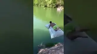 Guy tries to jump in the water with a large airbag, but it doesn't go so well!