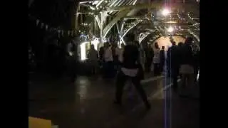 Guests polka - ing at the end of a wedding barn dance