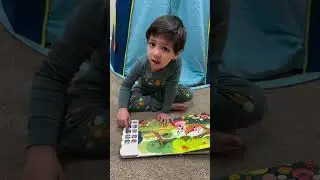 A child playing with our Go Go sound book #childrenssongs #soundbooks #multiculturalchildrensbooks