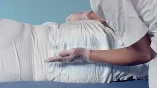 Instructions for how to apply TENA Slip Original on a user lying down