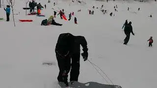 No snowboard so using a sled instead...suring in the snow